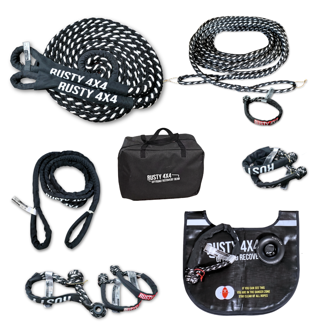 Rusty 4X4 recovery gear kit including black and white snatch straps, a black carrying bag, and a black recovery blanket on a white background.