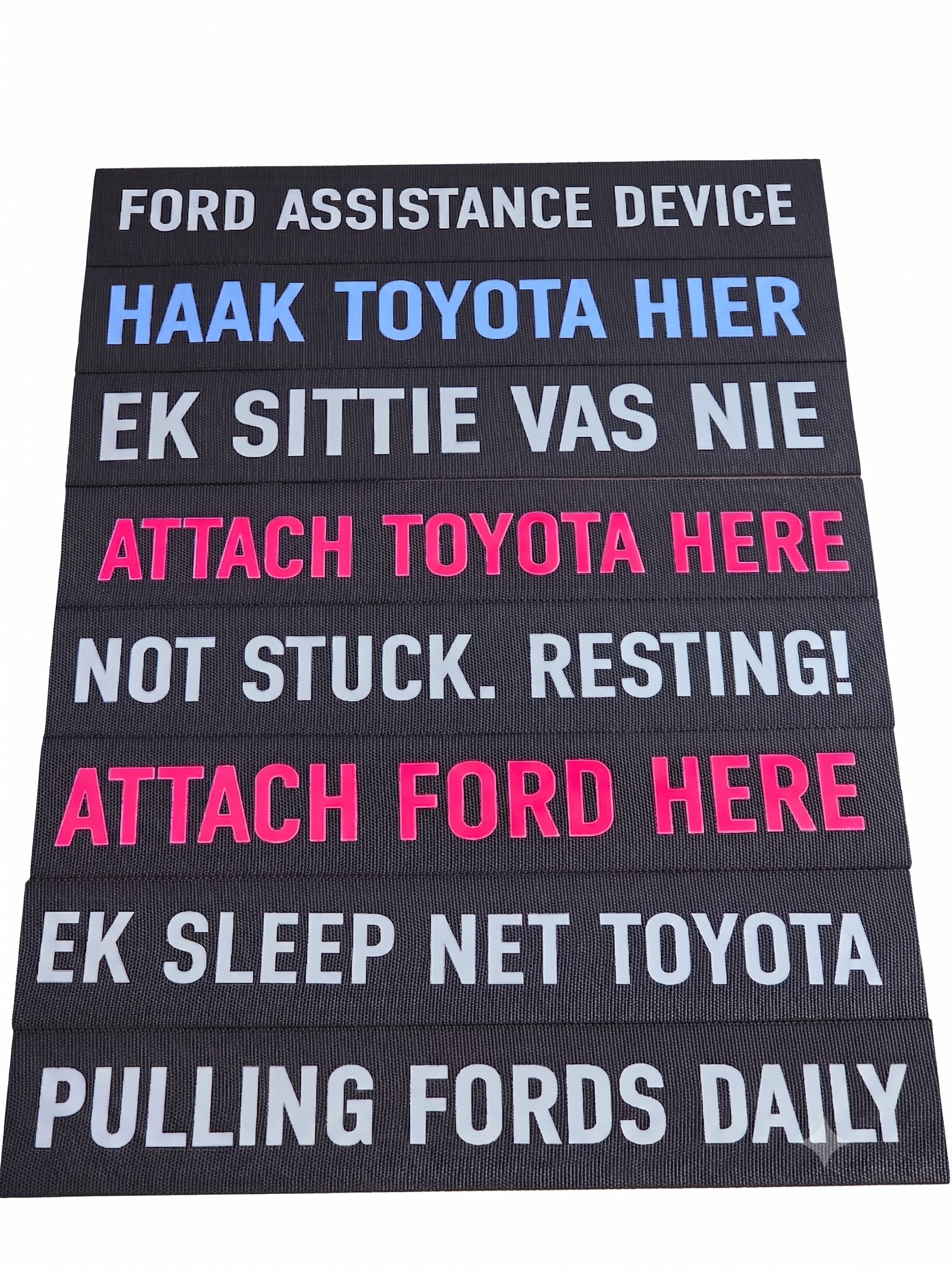 Textile panel showing printed “FORD ASSISTANCE DEVICE” and “PULLING FORDS DAILY”