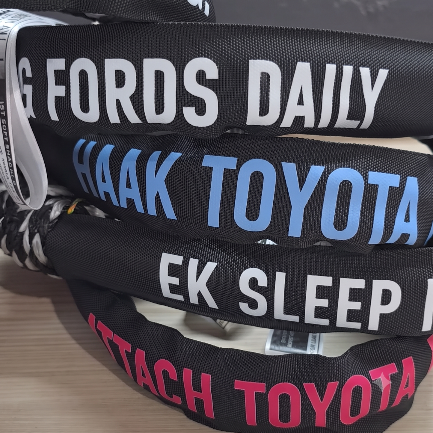 Stacked black soft shackles with large printed “HAak TOYOTA” and “EK SLEEP”