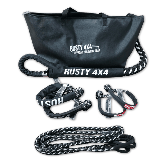 Off-road recovery kit items: duffel bag, web straps, metal shackles, and rope