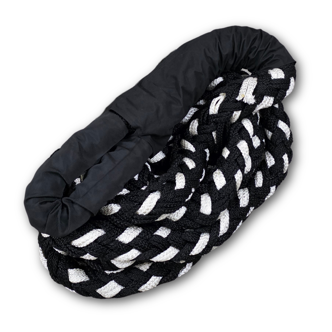 Kinetic recovery rope close-up with braided black and white strands and black strap