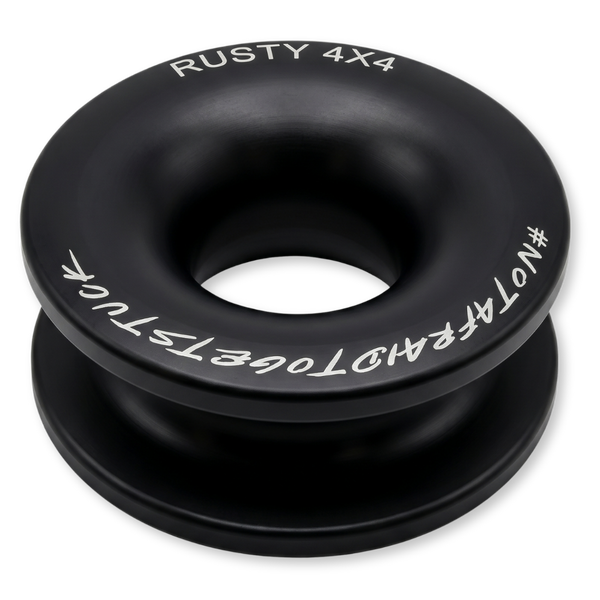 Black winch ring with central hole, white text branding and markings around edge