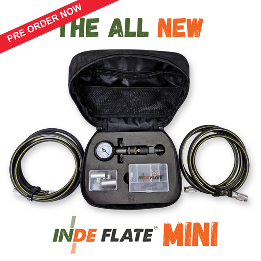 Portable tire inflator kit with open case, gauge, and coiled hoses