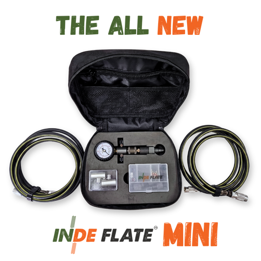Portable tire inflator kit with open black case, gauge, and coiled hoses