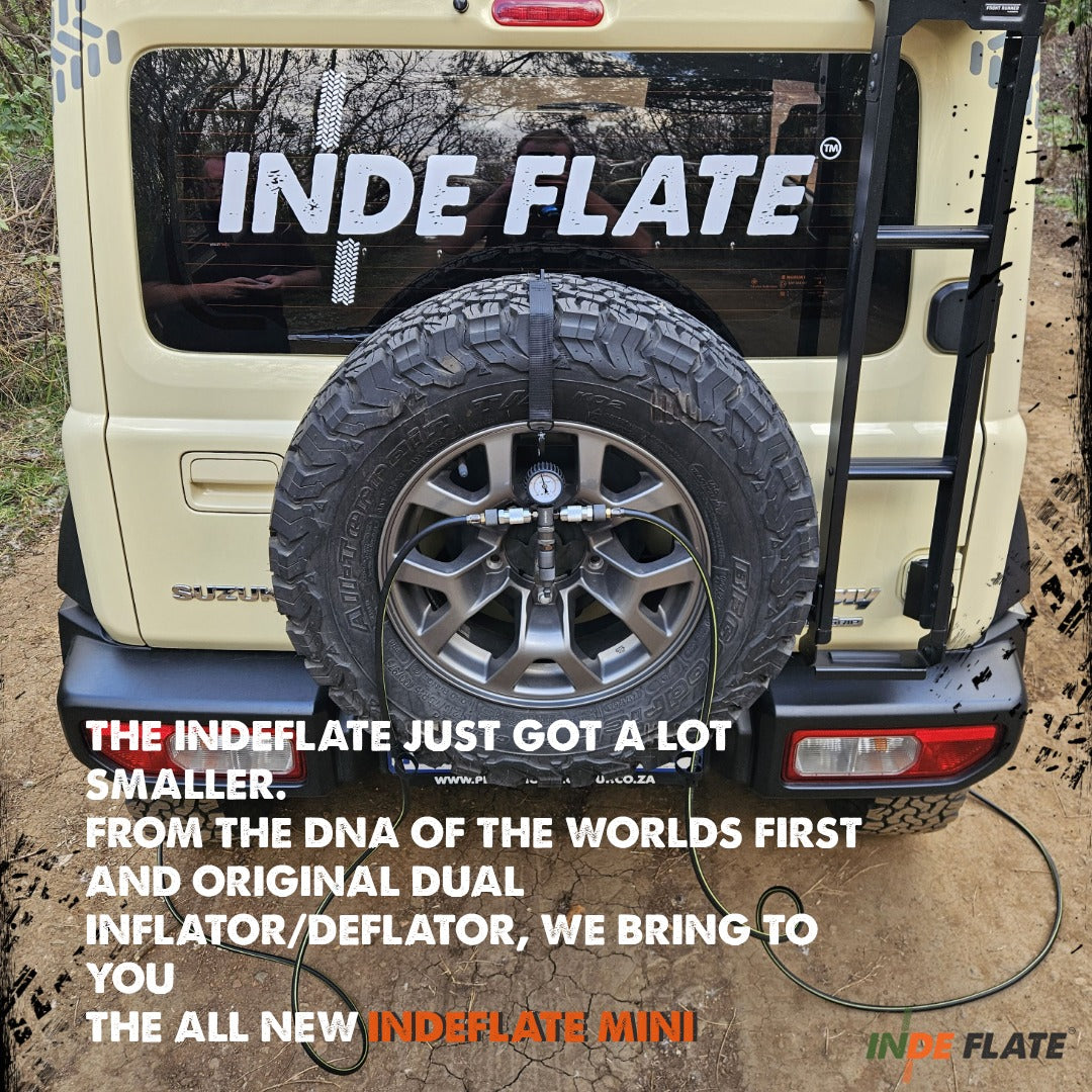 A spare tire mounted on the back of a beige off-road vehicle, with a black strap holding a smaller deflated tire attached to a charging port. Large white text on the vehicle reads INDE FLATE, and promotional text overlays describe the new INDEFLATE Mini dual inflater.